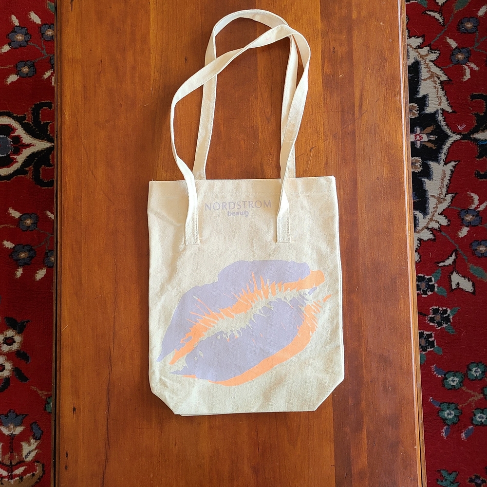 Nordstrom canvas bag, cream color with purple and orange lip imprint beauty bag